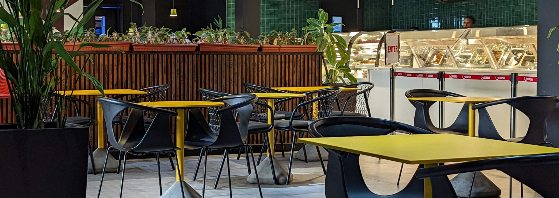 a restaurant filled with lots of tables and chairs