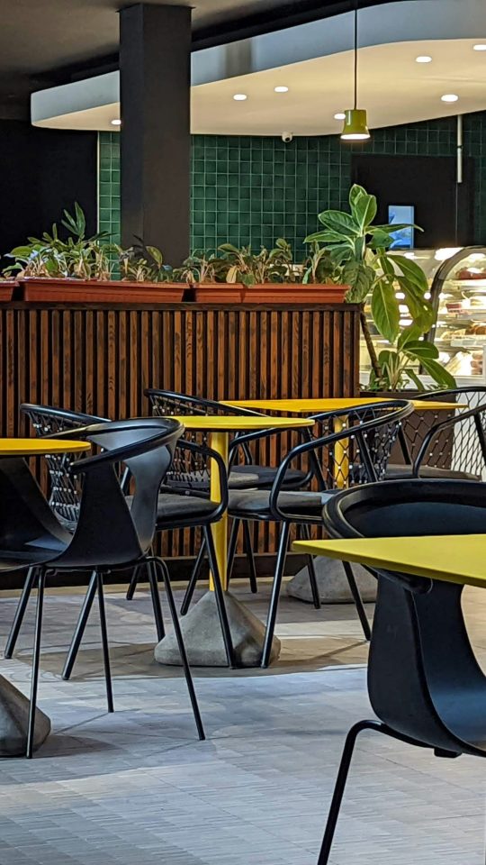 a restaurant filled with lots of tables and chairs