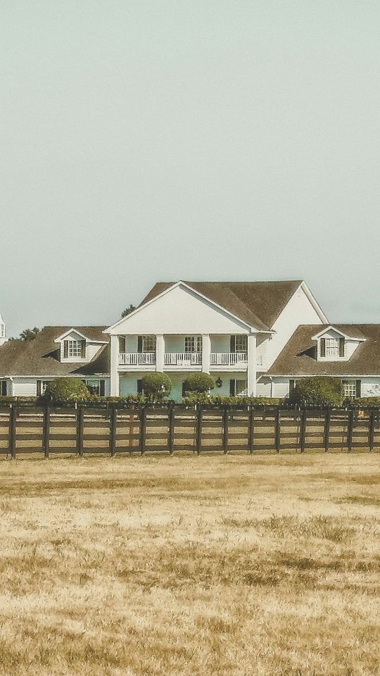 white 2-story house near green trees