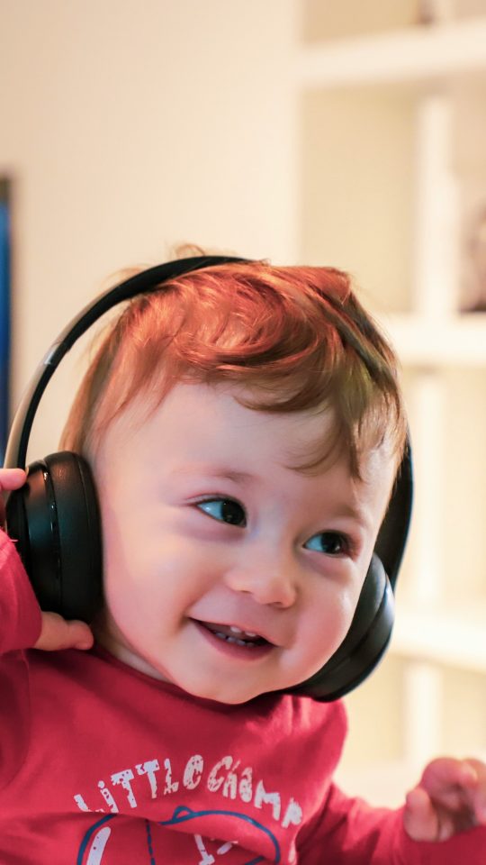 baby listening in black headset