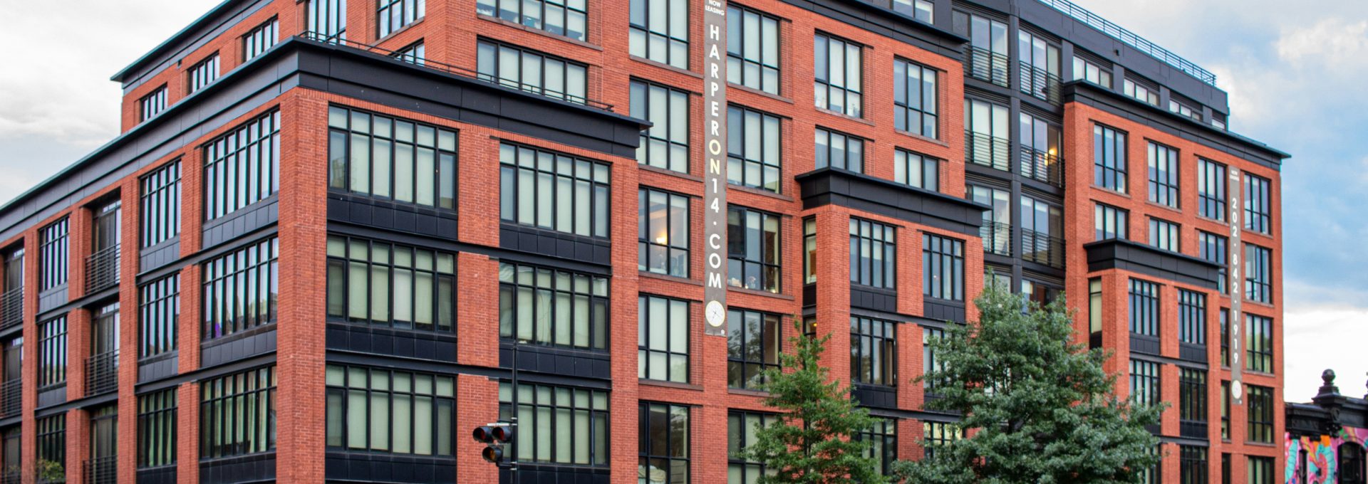 A large red brick building sitting on the corner of a street