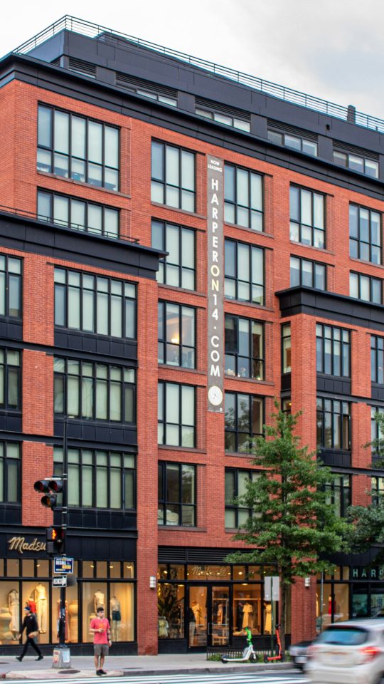 A large red brick building sitting on the corner of a street